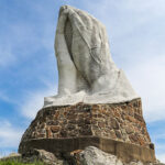 Praying hands statue