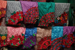 Embroidered huipiles (women's blouses) in the Momostenango market. Photo by Whirling Phoenix, Flickr.
