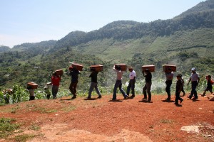 Carrying remains of loved ones after exhumation. Photo by Flickr user Trocaire.